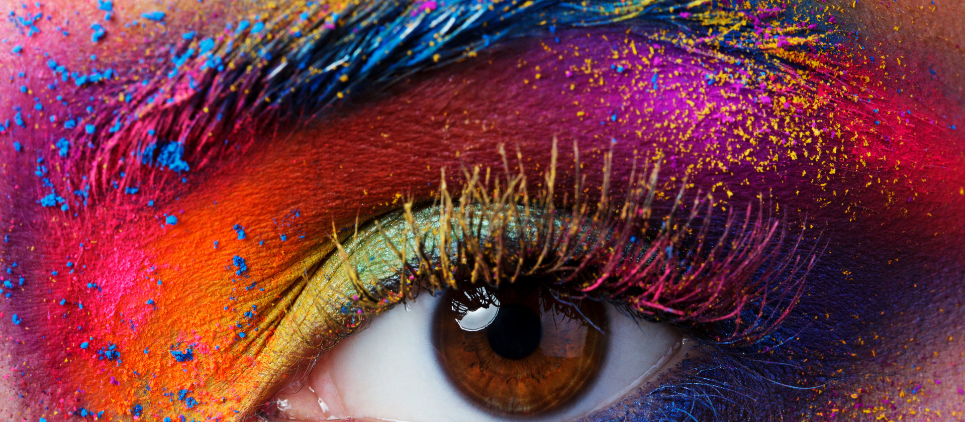 Close up view of female eye with bright multicolored fashion mak